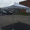 Image of 10x10 white Premium frame tent installed on asphalt