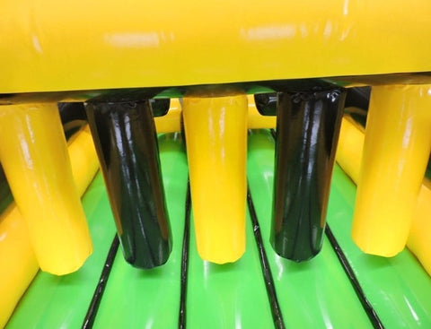 Close-up of interior pillars inside inflatable obstacle course showing yellow and black padded barriers