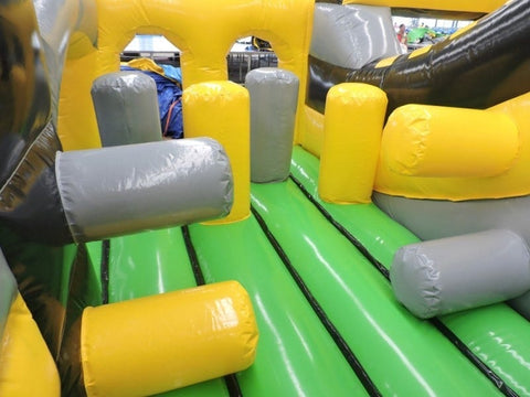 Interior section of Venom Radical Run inflatable obstacle course with yellow and gray pop-up obstacles
