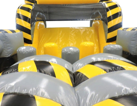 Interior of yellow and gray inflatable obstacle course showing soft inflated barriers and slide section