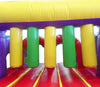 Image of Inside view of inflatable obstacle course showing yellow and green pop-up pillars for climbing challenges